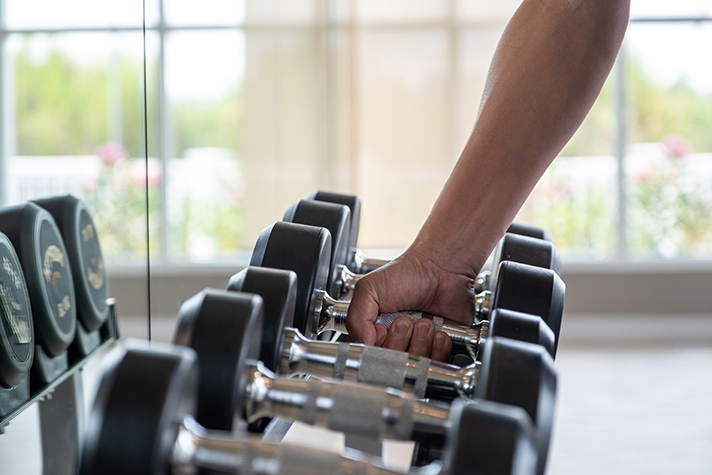 Close,Up,Man,Hand,Picking,Or,Choosing,Dumbbell,From,Dumbbell